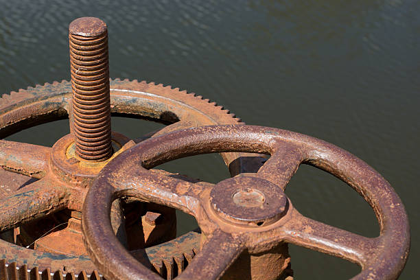 istock Rusted bolts screwed big gear sunlight. It is opening the 621992024