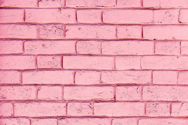 istock Pink color of brick wall texture background 621992400