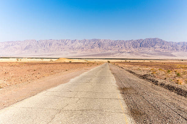 istock Desert asphalt road mountains range Israel Jordan border . 621992512