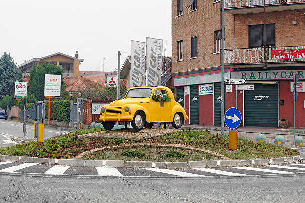 Turin, Italy - Fiat Topolino 500 c Oldtimer Turin, Italy - October 2, 2016: Model of Fiat Topolino 500 C oldtimer from 1936-57 is palced at one roundabout in Borgaro, a suburb of Turin fiat 500 topolino stock pictures, royalty-free photos & images
