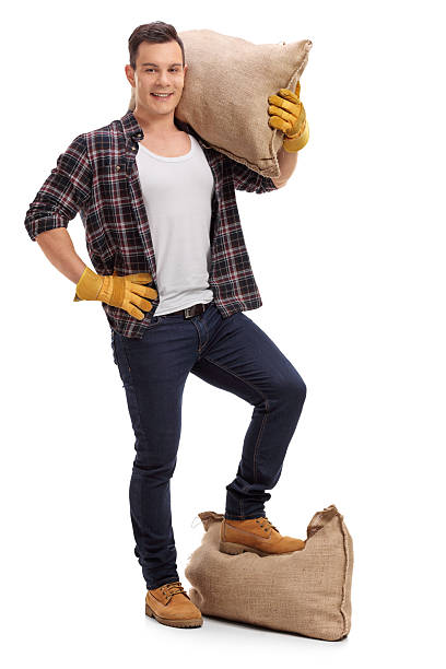 istock Farmer with burlap sack on shoulder and under foot 621994730