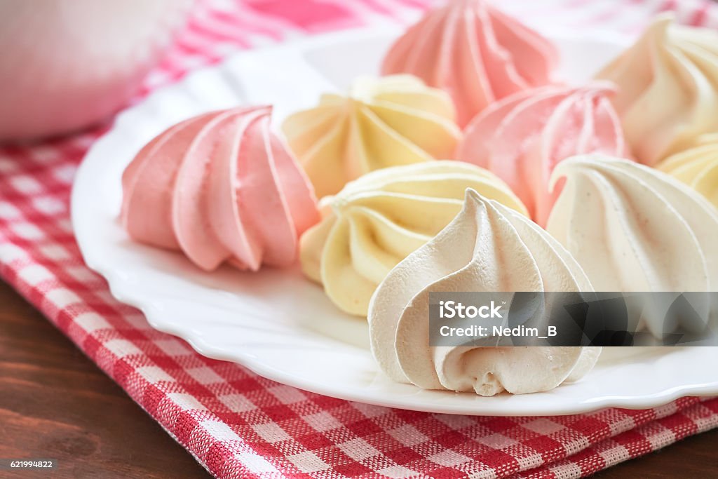 Colored meringue cookies Fresh delicious colored meringue cookies served on white plate Meringue Stock Photo