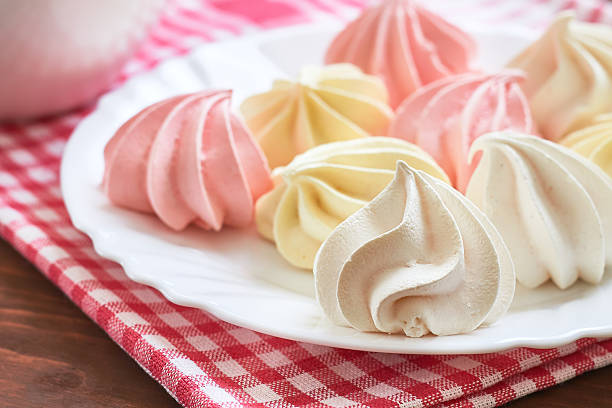 Colored meringue cookies Fresh delicious colored meringue cookies served on white plate meringue stock pictures, royalty-free photos & images
