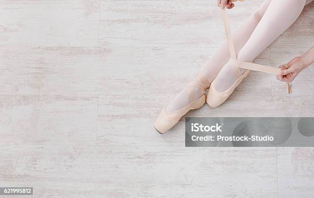 Ballerina Puts On Pointe Ballet Shoes Graceful Legs Stock Photo - Download Image Now