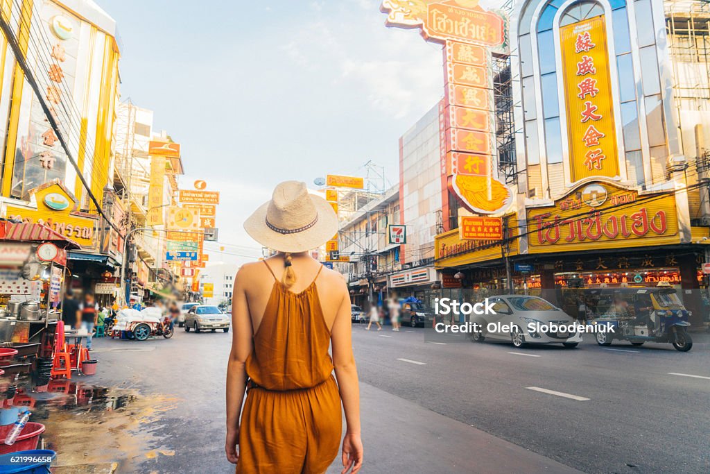 Woman walking in Chianatown Young Caucasian Woman walking in Chianatown in Bangkok  Bangkok Stock Photo