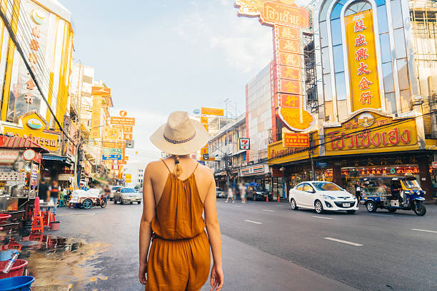 Woman walking in Chianatown Young Caucasian Woman walking in Chianatown in Bangkok bangkok street stock pictures, royalty-free photos & images