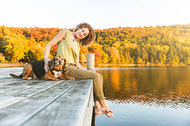 istock Woman and dog relaxing on the dock 621997774