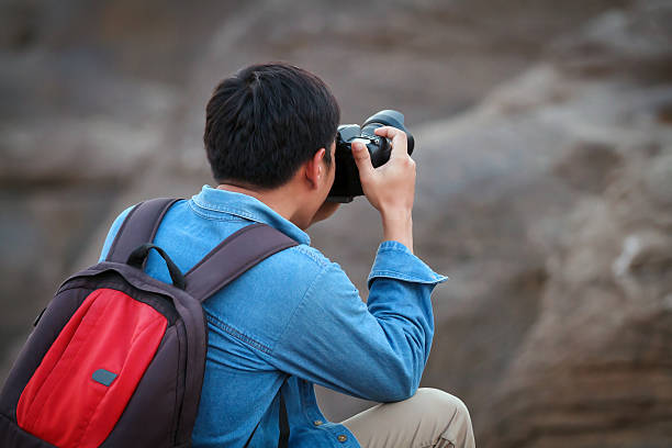 istock man asia with backpack taking a photo 621998878