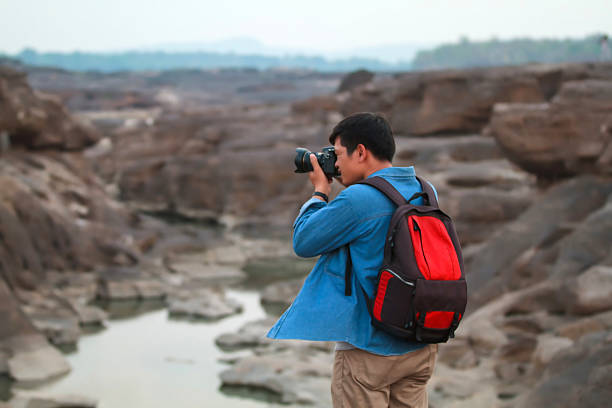 istock Blurry of  man asia with backpack taking a photo 621999472