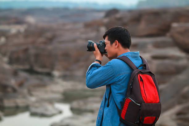 istock Blurry of  man asia with backpack taking a photo 621999512