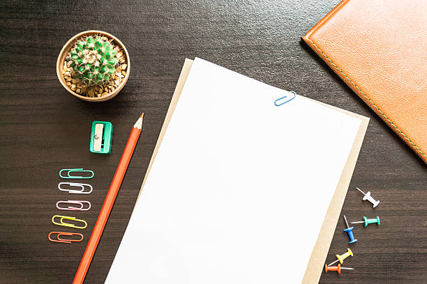 istock Blank white paper and colored pencil on the desk. 621999814