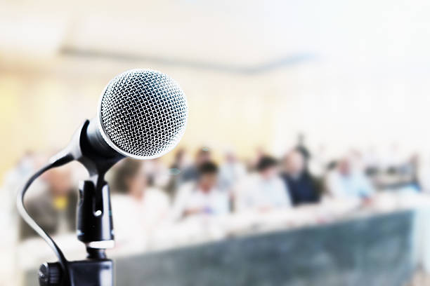istock Shiny microphone and defocused audience waiting for speaker 622000838