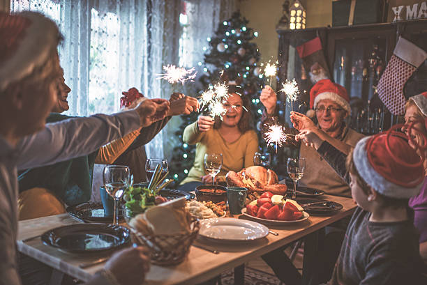 Family celebrating Christmas for many years together Family celebrating Christmas for many years together roast dinner photos stock pictures, royalty-free photos & images