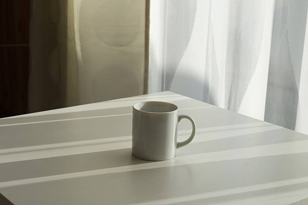 istock white pills lying next to a glass of water on 622001248