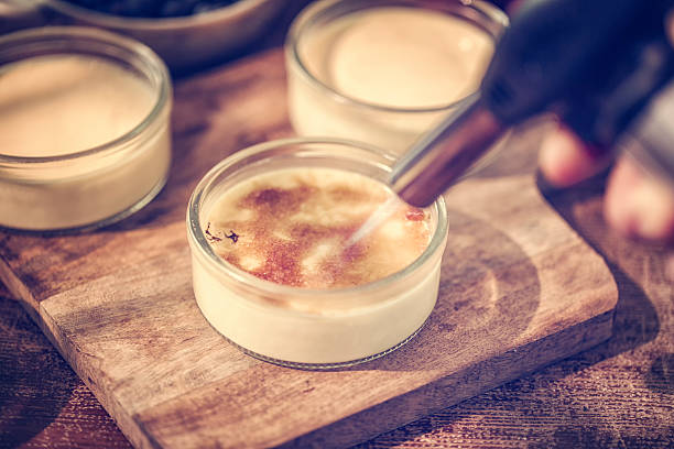 Preparing Homemade Creme Brulee with fresh berries