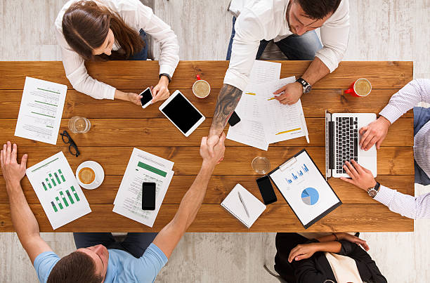 istock Business people group handshake in office, top view 622003944