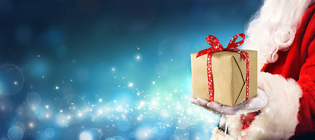 istock Santa Claus Giving Gift Box In Magic Night 622003960