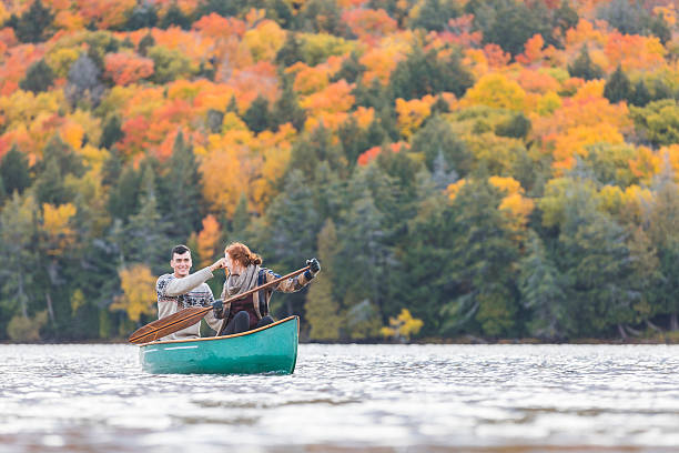 heureux couple canoë dans un lac au canada - beauty teenage girls women in a row photos et images de collection