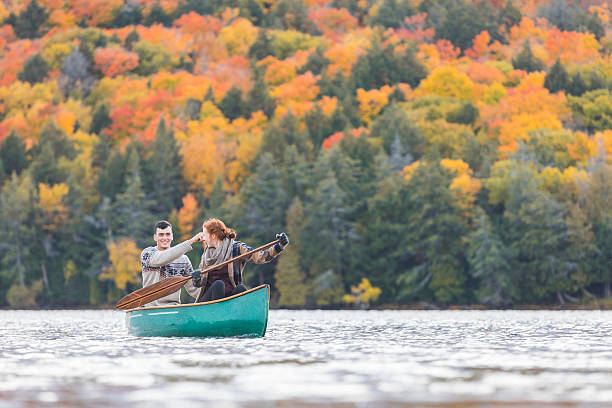 istock Happy couple canoeing in a lake in Canada 622004676