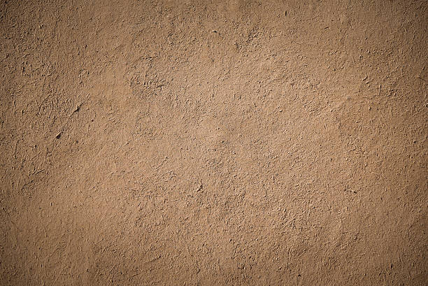 old brown stucco clay wall closeup detail of old brown stucco clay wall, rough surface background or backdrop in architectural material concept mud stock pictures, royalty-free photos & images