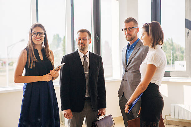 istock four business people handshake in office lobby 622005014