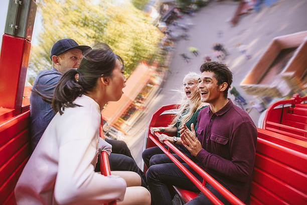 istock Happy young friends having fun on amusement park ride 622005042