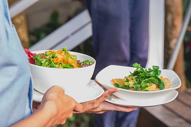 istock Waiter serving fresh green salad 622007028