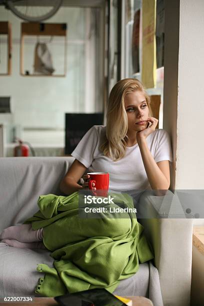 Woman Resting In A Couch Stock Photo - Download Image Now - Adult, Adults Only, Blond Hair
