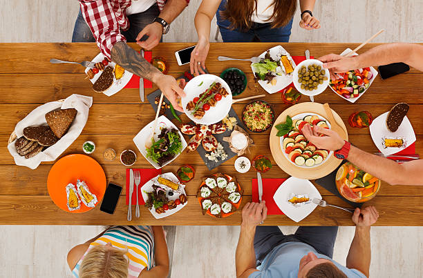 istock People eat healthy meals at festive table dinner party 622008550