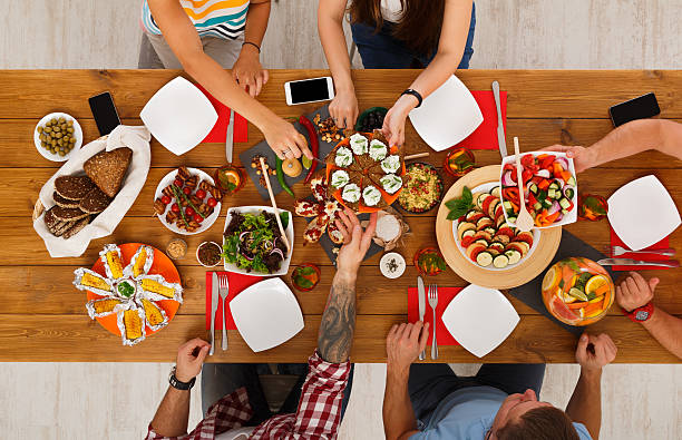 istock People eat healthy meals at served table dinner party 622008724