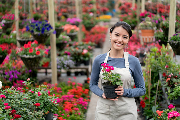 istock Happy woman working at a garden center 622009084