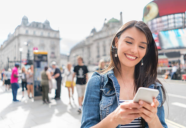 istock Woman in London using her cell phone 622009936