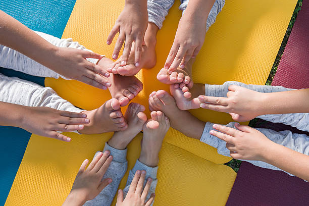 istock group of child exercise yoga outdoors 622012186