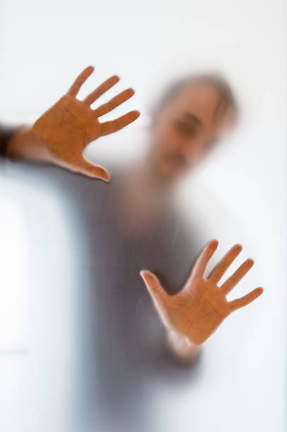 istock Shadowy man figure behind a frosted glass 622014884
