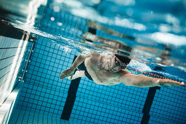 istock Young man swimming the front crawl in a pool. 622015834