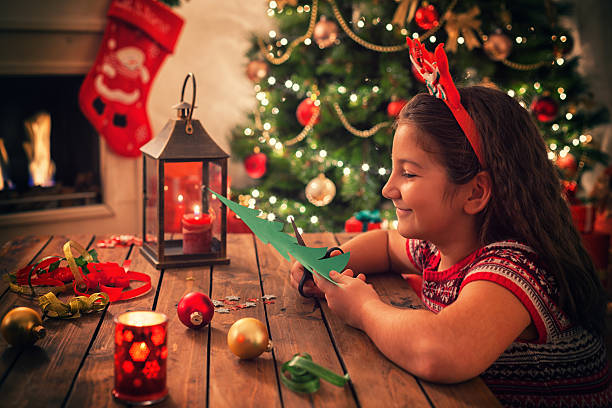 Little Girl Making Christmas Card stock photo