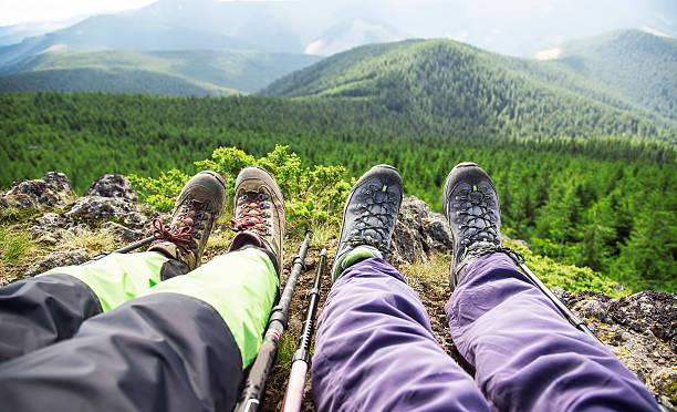 istock Hiker boots and legs resting on the mountain peak 622031390