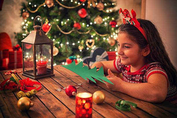 istock Little Girl Making Christmas Card 622031428