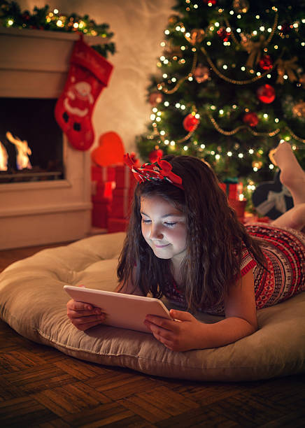 istock Beautiful little girl using digital tablet on Christmas night 622033214