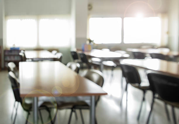istock Blurred table and chair in public library with sunlight 622033478