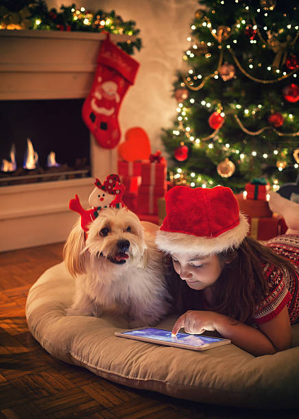 istock Beautiful little girl using digital tablet on Christmas night 622033560