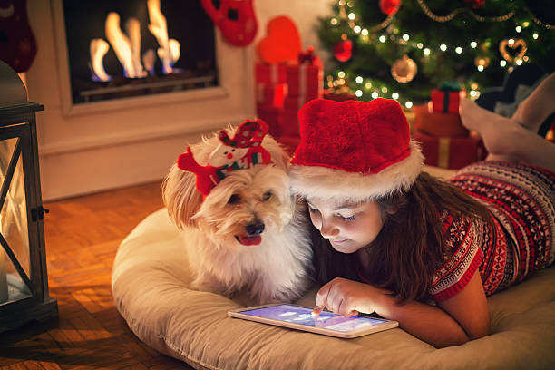 Beautiful little girl using digital tablet on Christmas night