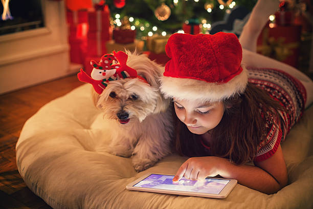 istock Beautiful little girl using digital tablet on Christmas night 622034740