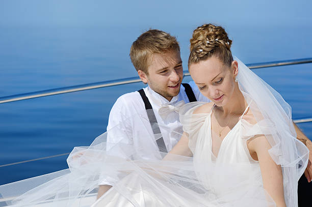 istock Happy bride and groom on a yacht 622035382
