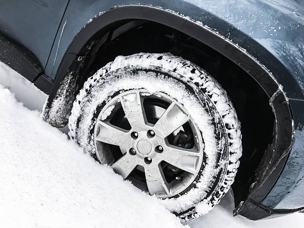 istock Car wheel with studded tire in snowdrift 622035732