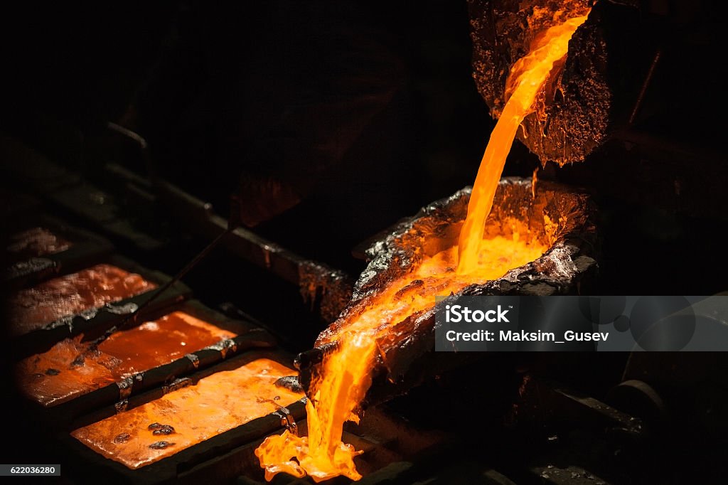 Molten metal at aluminium foundry Production of aluminium master alloys on a foundry Aluminum Stock Photo