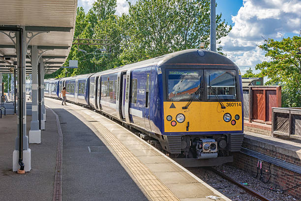 Class 360 Desiro train at Walton-on-the-Naze station Walton-on-the-Naze, UK - July 17th 2016: Class 360 Desiro electric multiple unit in Abbelio Greater Anglia livery is awaiting departure for Thorpe-Le-Soken. A passenger is about to board the train. clacton on sea stock pictures, royalty-free photos & images
