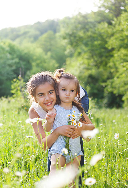 istock Two happy sisters in the spring field 622043782