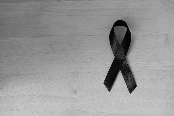 Shiny black ribbon bow fabric texture detail pattern Shiny black ribbon bow fabric texture detail pattern : Ribbon awareness symbol of remembrance campaign or mourning over person's death: Pray for world peace concept: RIP, Black and White self mutilation pictures stock pictures, royalty-free photos & images