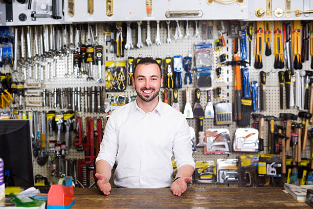 istock Smiling young man cashier standing at pay desk 622044698